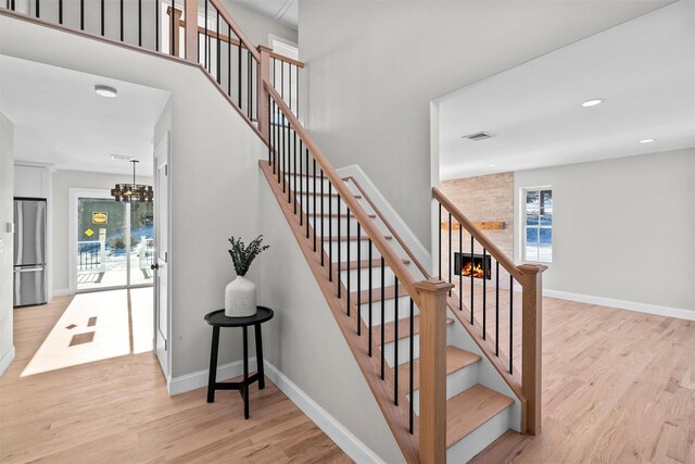 stairs featuring recessed lighting, visible vents, baseboards, and wood finished floors