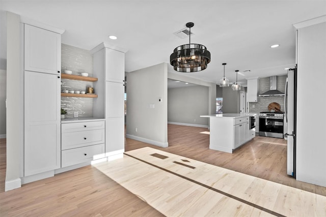 kitchen with open shelves, light countertops, appliances with stainless steel finishes, white cabinets, and a kitchen island