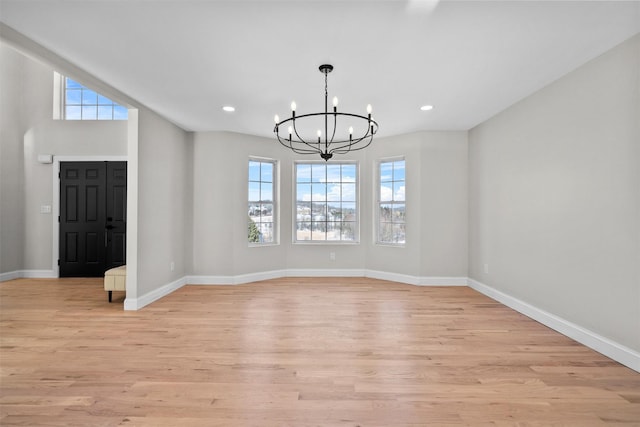 entrance foyer featuring a chandelier, recessed lighting, light wood-style flooring, and baseboards