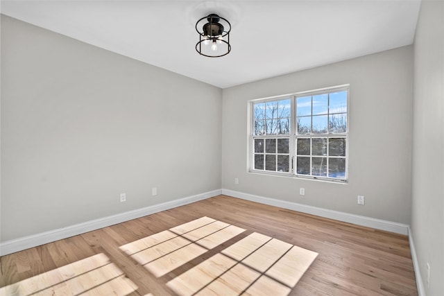 unfurnished room featuring light wood-style flooring and baseboards