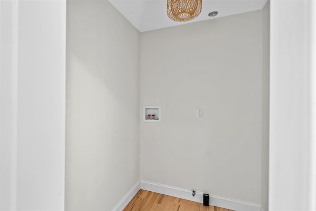 laundry area featuring washer hookup, gas dryer hookup, wood finished floors, laundry area, and baseboards