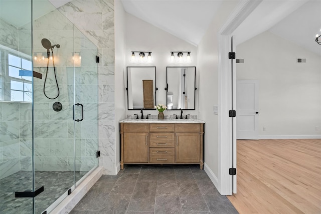 full bathroom with a stall shower, visible vents, a sink, and baseboards