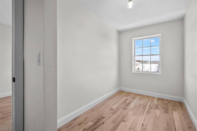 empty room featuring light wood-style flooring and baseboards