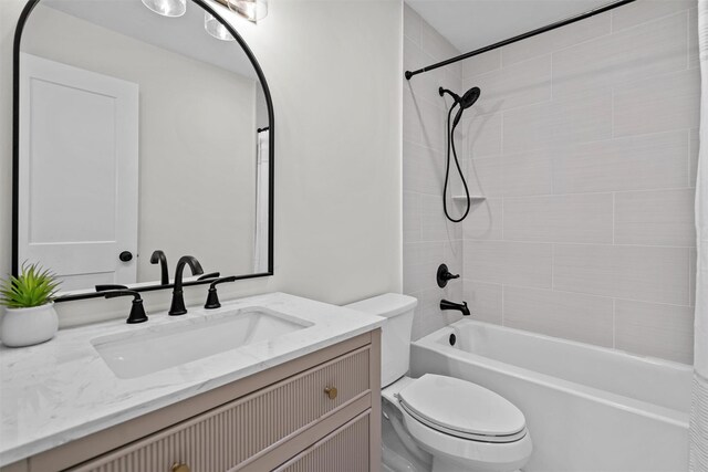 full bathroom featuring toilet, tub / shower combination, and vanity