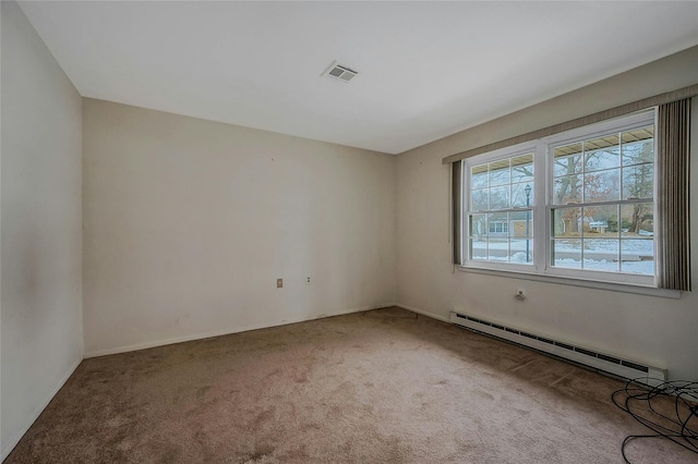 unfurnished room with baseboard heating, carpet, and visible vents