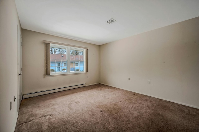 carpeted spare room featuring visible vents, a baseboard heating unit, and baseboards