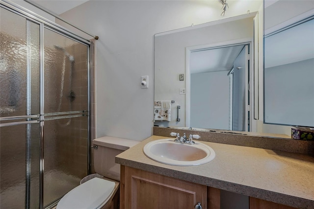 full bath featuring toilet, a shower stall, and vanity