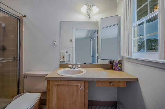 bathroom featuring toilet, a stall shower, and vanity