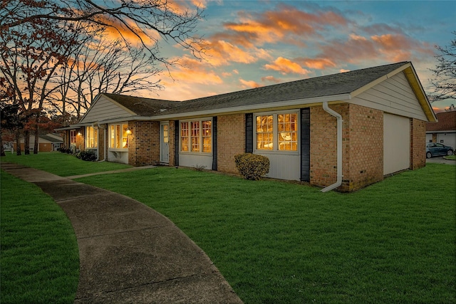 back of house featuring a yard and brick siding