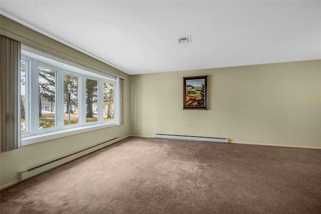 spare room with a baseboard heating unit, visible vents, and carpet floors