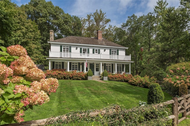 500 Hardscrabble Rd, Briarcliff Manor, NY 10510 - view of front of house with a porch, a chimney, a balcony, and a front lawn