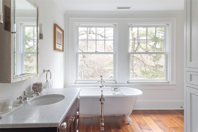 500 Hardscrabble Rd, Briarcliff Manor, NY 10510 - bathroom with wood finished floors, visible vents, a soaking tub, and plenty of natural light