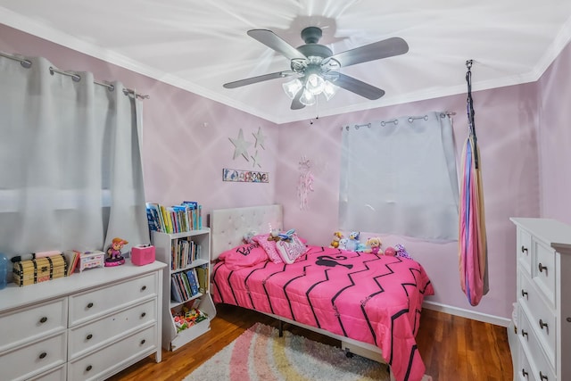 bedroom featuring ceiling fan, ornamental molding, and dark hardwood / wood-style floors