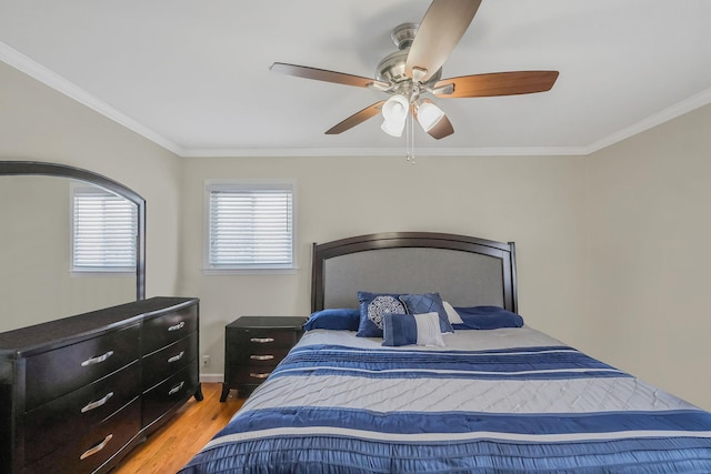 bedroom featuring ceiling fan, ornamental molding, and light hardwood / wood-style floors