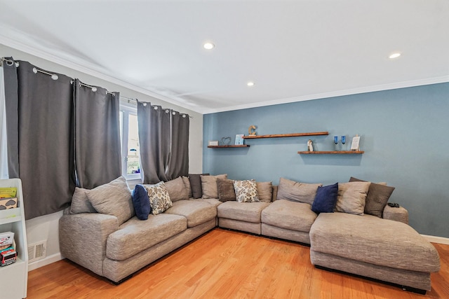 living room featuring crown molding and hardwood / wood-style flooring