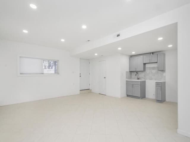 unfurnished living room with sink