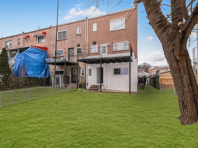 rear view of property featuring a lawn