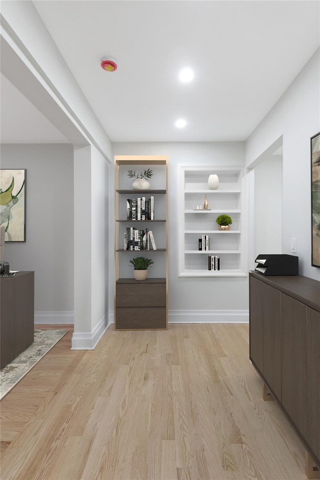 interior space featuring light hardwood / wood-style floors and built in shelves