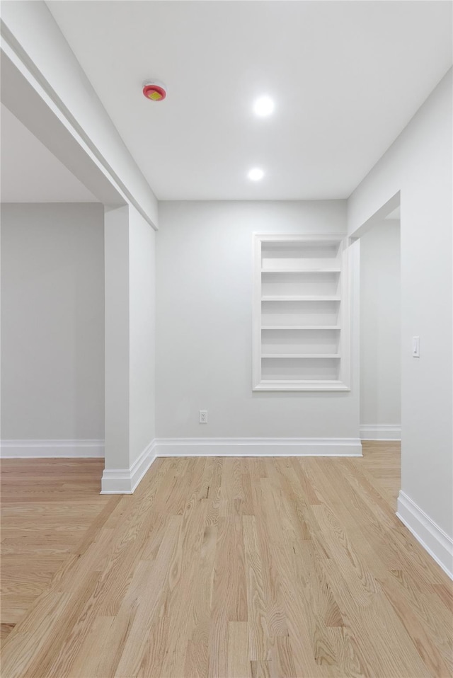 basement with light hardwood / wood-style floors