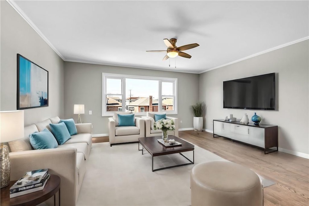 living room featuring ornamental molding, ceiling fan, and light hardwood / wood-style flooring