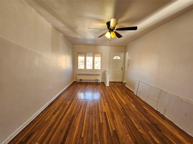 interior space with radiator, dark wood-type flooring, and ceiling fan