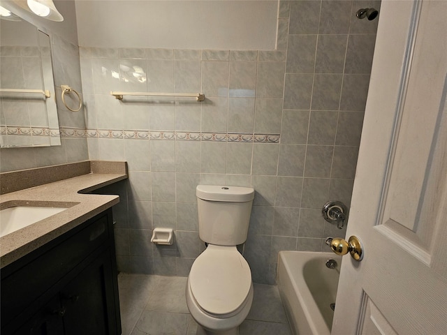 full bathroom featuring shower / bathing tub combination, tile walls, vanity, toilet, and tile patterned floors