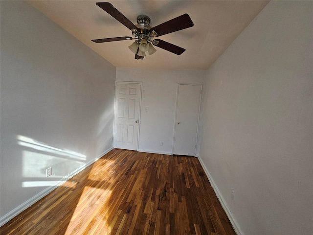 unfurnished bedroom featuring dark hardwood / wood-style flooring and ceiling fan