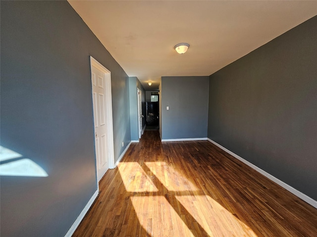 empty room featuring dark hardwood / wood-style flooring