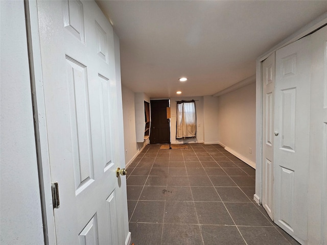 hallway with dark tile patterned flooring