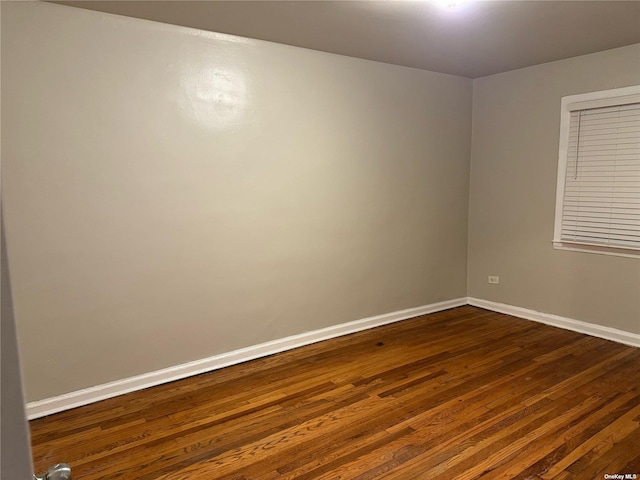 spare room with dark wood-type flooring