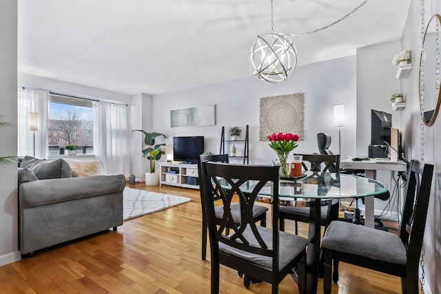 dining room featuring hardwood / wood-style flooring and a chandelier