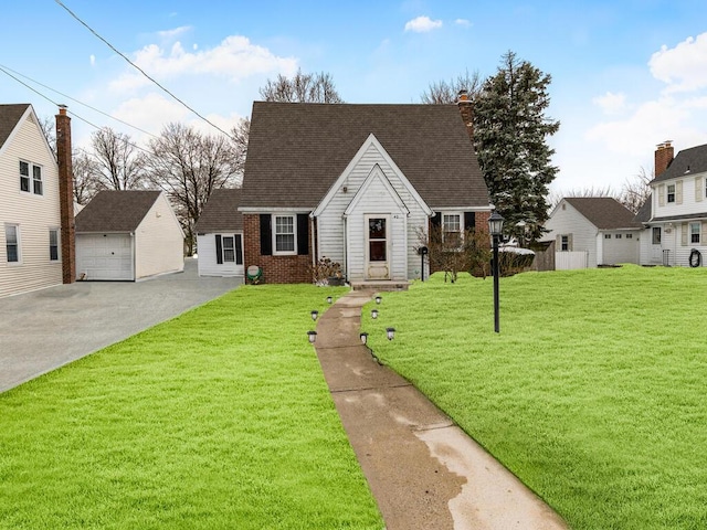 view of front of home featuring an outbuilding, a garage, and a front lawn