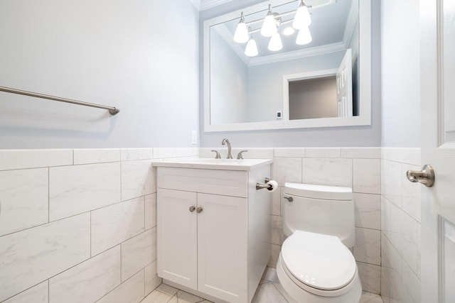 bathroom featuring vanity, ornamental molding, tile walls, and toilet