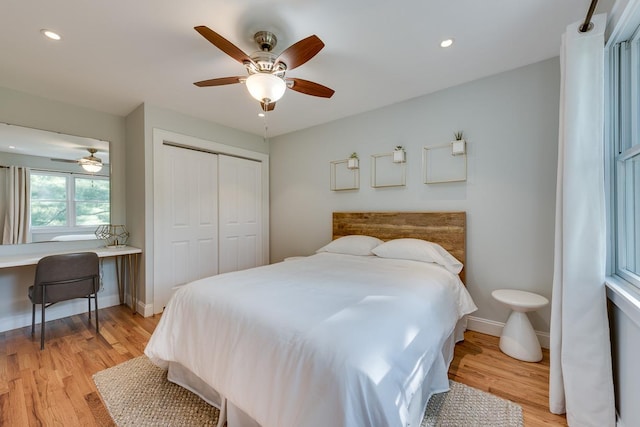 bedroom featuring a closet, ceiling fan, and light hardwood / wood-style flooring