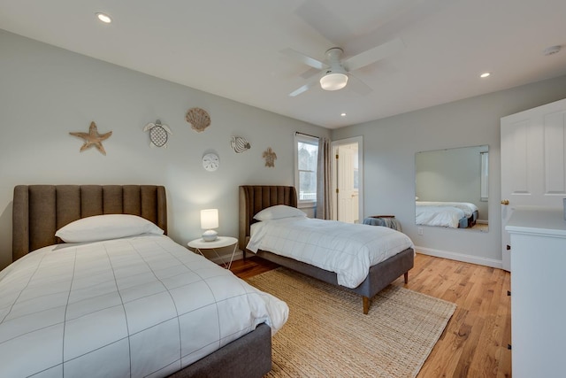 bedroom featuring ceiling fan and light hardwood / wood-style flooring