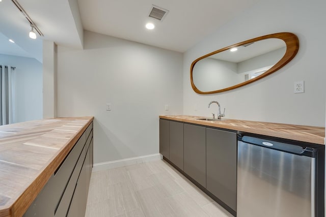 bathroom with vanity, lofted ceiling, and track lighting