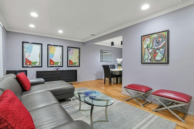 living area featuring baseboards, ornamental molding, wood finished floors, and recessed lighting