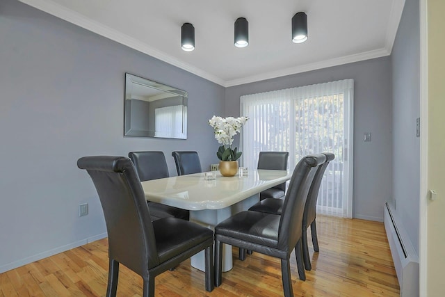 dining space featuring ornamental molding, baseboards, light wood-style flooring, and baseboard heating