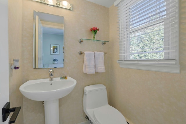 half bathroom featuring a sink and toilet