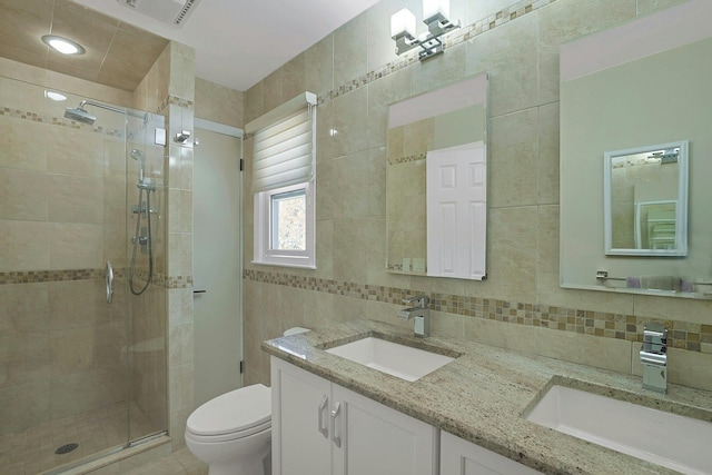 full bath featuring a stall shower, a sink, and visible vents