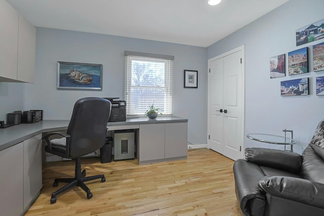 home office with light wood-style floors