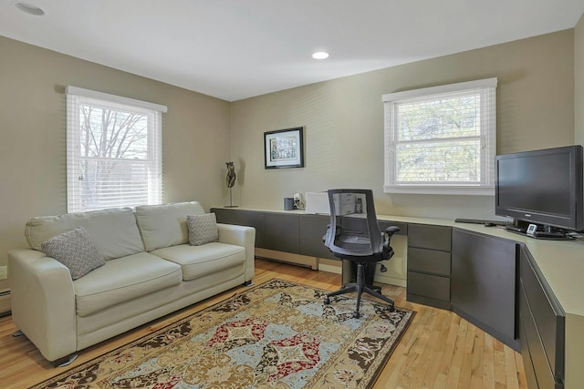 office area featuring light wood-style floors, built in desk, and recessed lighting