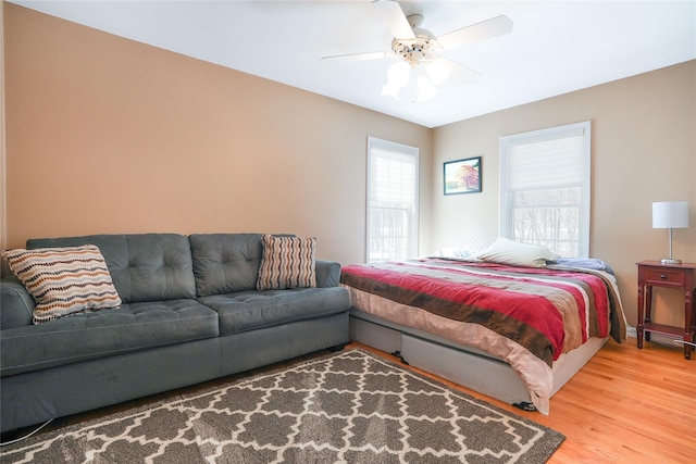 bedroom with light wood-style flooring and ceiling fan