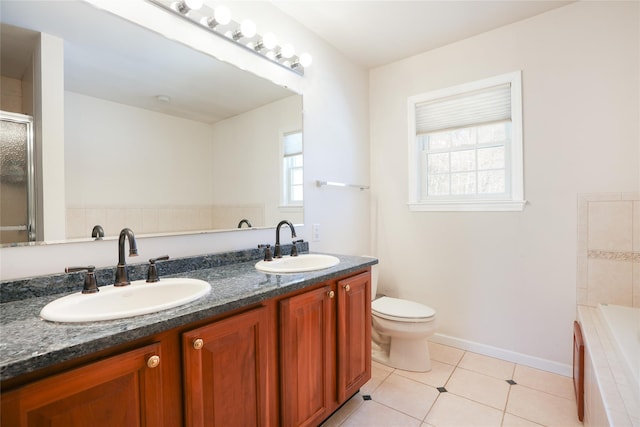 bathroom with tile patterned flooring, a sink, toilet, and double vanity