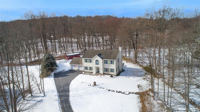 snowy aerial view with a view of trees