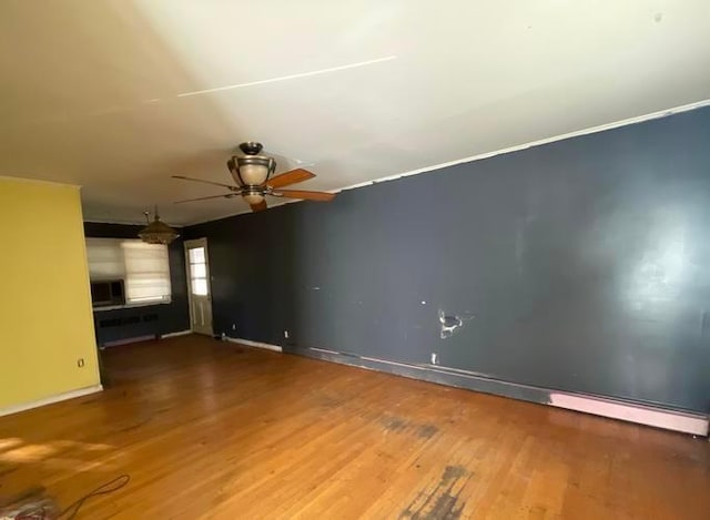 unfurnished living room with hardwood / wood-style flooring and ceiling fan