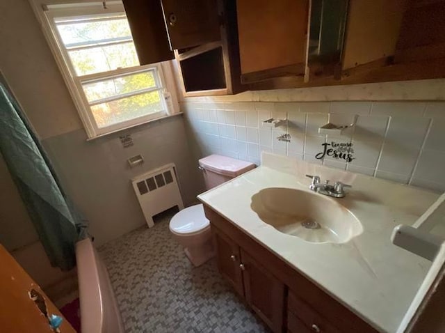 55 S Brookside Ave, Freeport, NY 11520 - full bathroom with radiator, tile walls, vanity, shower / tub combo, and toilet