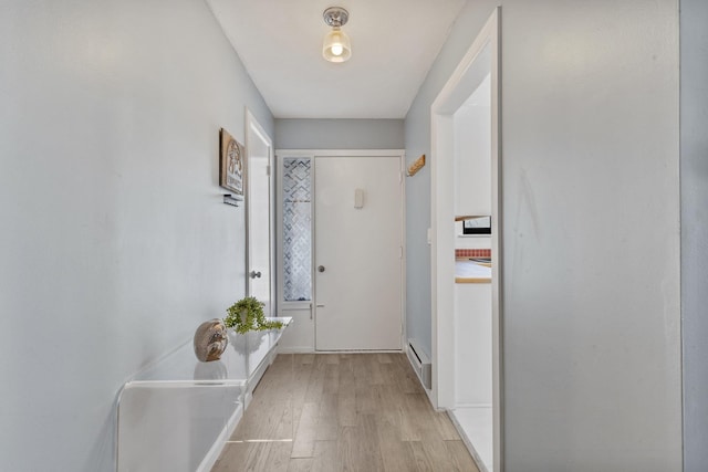 doorway to outside with light wood-type flooring