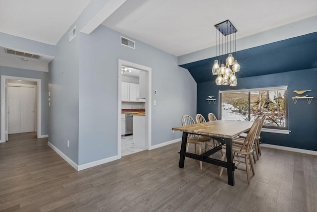 dining area featuring baseboards, visible vents, and a notable chandelier