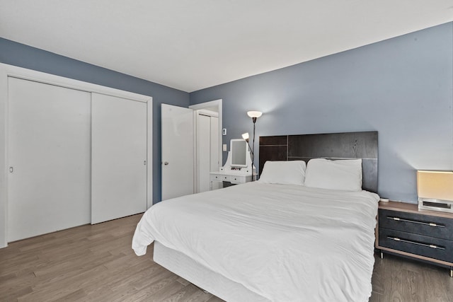 bedroom featuring a closet and wood finished floors